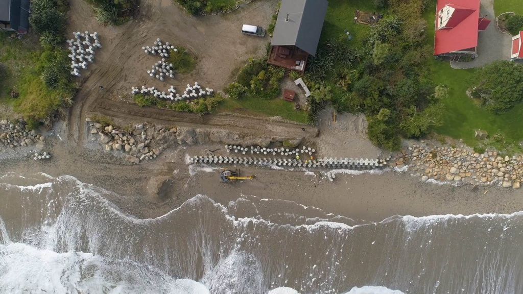 A birds eye view of the concrete wall in the works by the shoreline